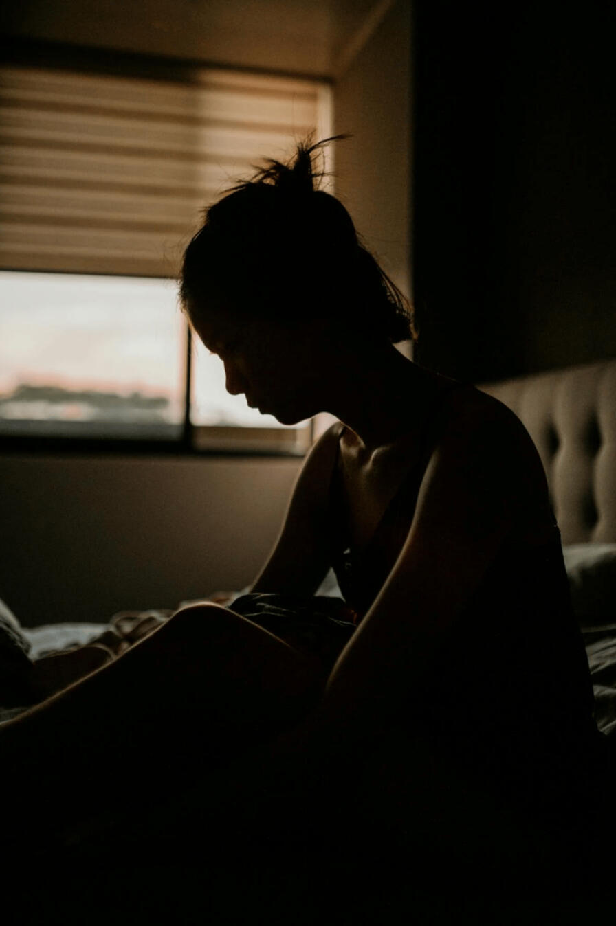 An ill lady sits up in bed to receive the warmth that comes from the psychic healing energy